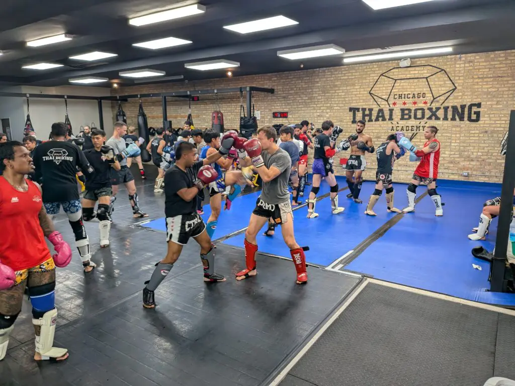 Adult class drilling on the mats at Chicago Thai Boxing Academy