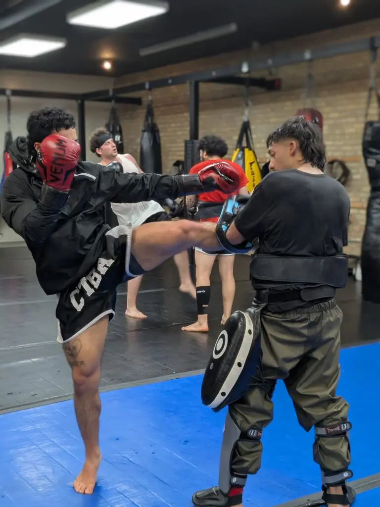 Coach holding pads for a fighter